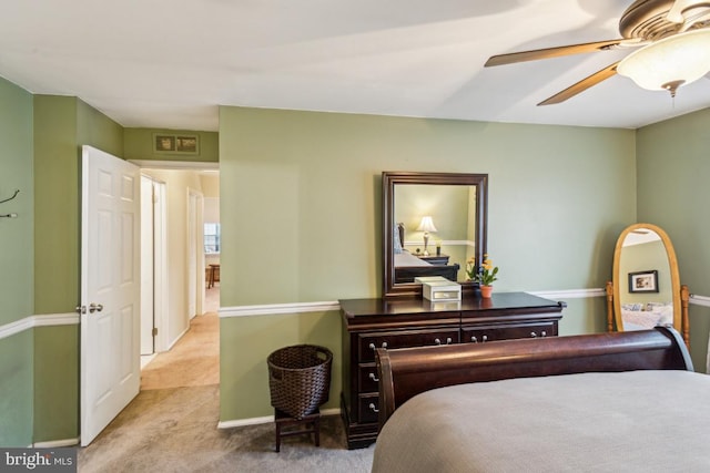 carpeted bedroom featuring ceiling fan and baseboards