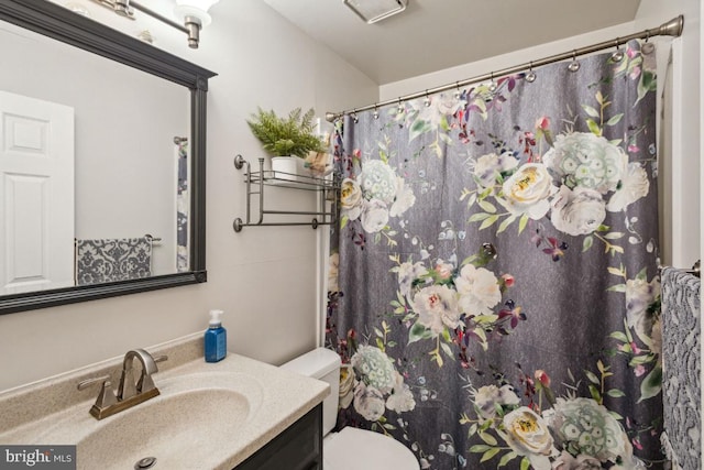 bathroom with vanity, toilet, and a shower with shower curtain