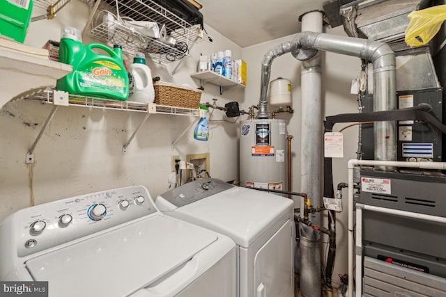 clothes washing area featuring separate washer and dryer and gas water heater