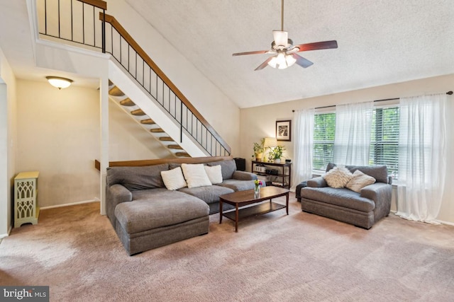 carpeted living room featuring ceiling fan, stairway, baseboards, high vaulted ceiling, and a textured ceiling