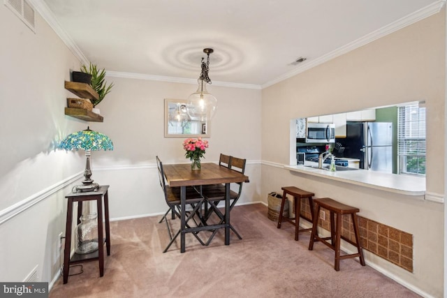 dining area with crown molding and light colored carpet