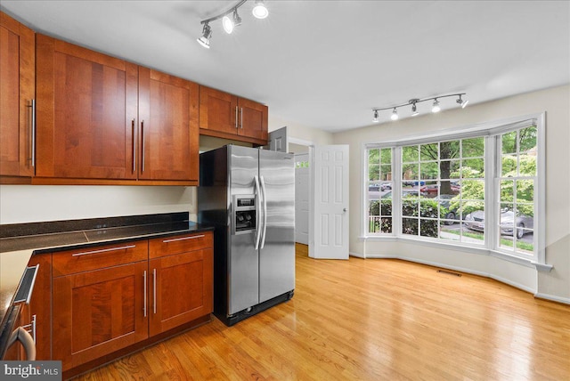 4516 4th Rd N, Arlington, VA 22203 - kitchen featuring stainless steel refrigerator with ice dispenser, track lighting, light wood finished floors, baseboards, and brown cabinetry