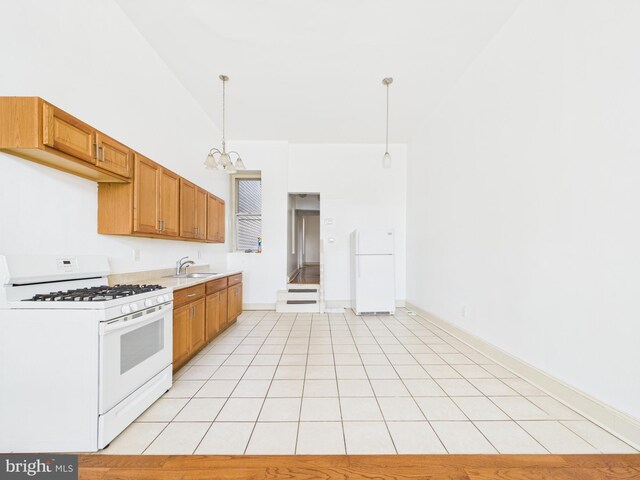 4712 Woodland Ave, Philadelphia, PA 19143 - kitchen featuring white appliances, a sink, a chandelier, light countertops, and pendant lighting