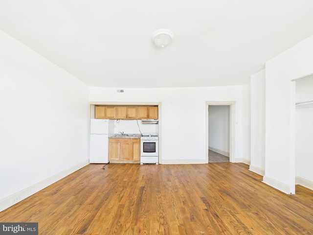 4712 Woodland Ave, Philadelphia, PA 19143 - unfurnished living room with a sink, wood finished floors, and baseboards