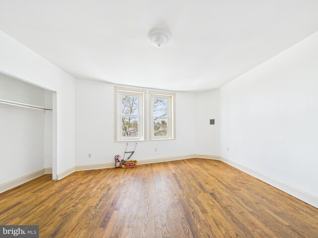 4712 Woodland Ave, Philadelphia, PA 19143 - unfurnished bedroom featuring wood finished floors, baseboards, and a closet