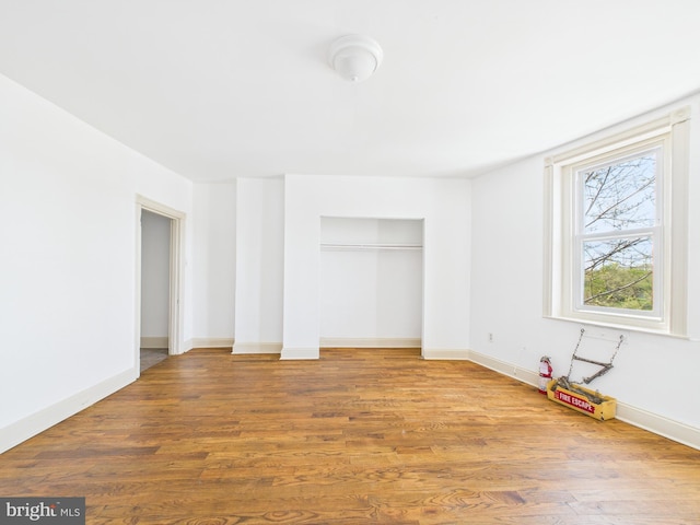 4712 Woodland Ave, Philadelphia, PA 19143 - unfurnished bedroom featuring wood finished floors, a closet, and baseboards