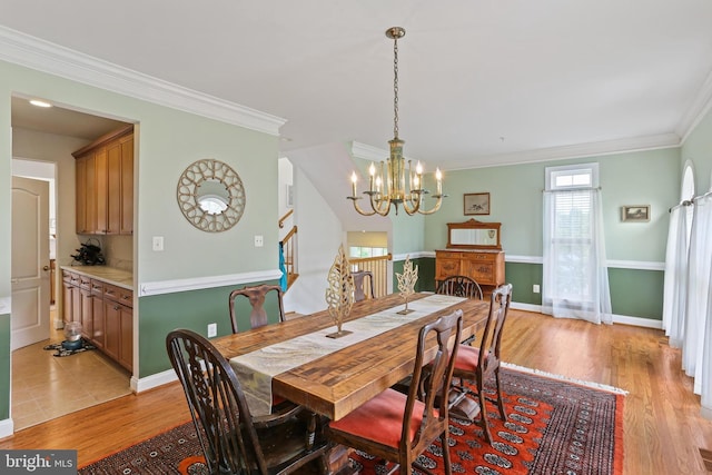 2714 Cabernet Ln, Annapolis, MD 21401 - dining room with plenty of natural light, a chandelier, crown molding, light wood-style floors, and stairs