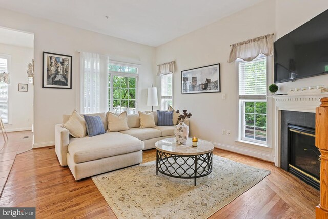 2714 Cabernet Ln, Annapolis, MD 21401 - living room with a glass covered fireplace, light wood-type flooring, and baseboards
