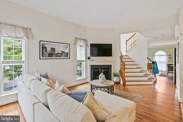 2714 Cabernet Ln, Annapolis, MD 21401 - living area featuring stairs, a glass covered fireplace, and light wood-style floors