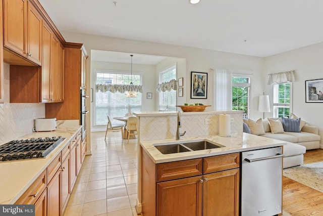 2714 Cabernet Ln, Annapolis, MD 21401 - kitchen featuring a sink, stainless steel appliances, a chandelier, open floor plan, and tasteful backsplash