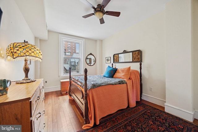 bedroom featuring wood-type flooring, baseboards, and ceiling fan