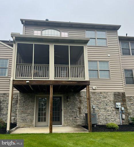 237 Fieldcrest Ln, Ephrata, PA 17522 - back of house with stone siding, a sunroom, and a patio