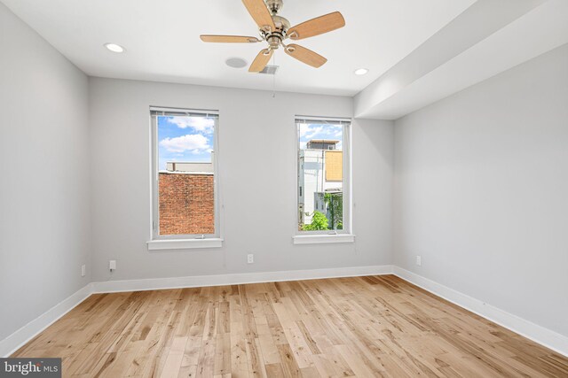empty room with light wood finished floors, baseboards, a ceiling fan, and recessed lighting