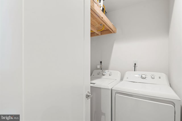 clothes washing area with washing machine and clothes dryer