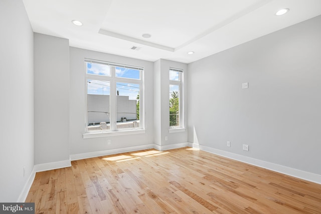 empty room with light wood-style flooring, baseboards, and recessed lighting