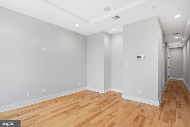 unfurnished room featuring light wood finished floors, baseboards, and recessed lighting