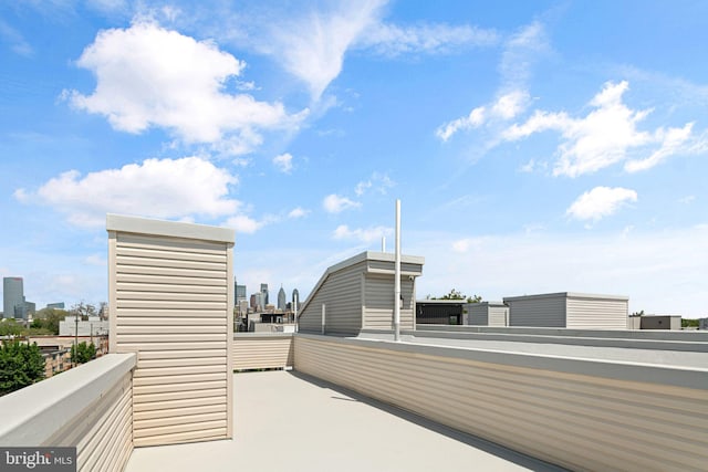 view of patio with a balcony and a skyline view
