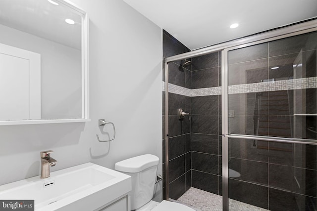 bathroom featuring a shower stall, toilet, recessed lighting, and vanity