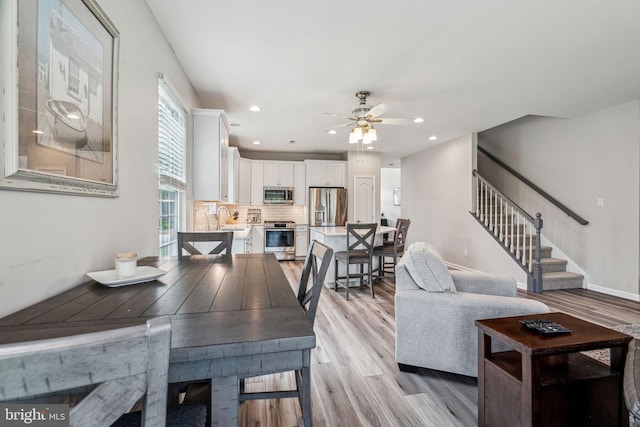 1723 Magnolia Ct, Garnet Valley, PA 19060 - dining space featuring a ceiling fan, light wood finished floors, stairway, and recessed lighting