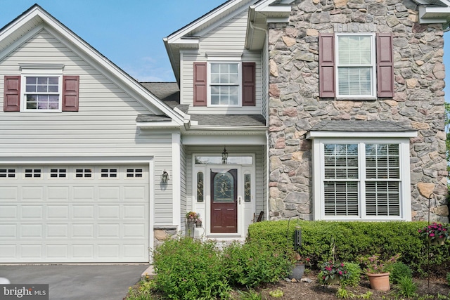 1723 Magnolia Ct, Garnet Valley, PA 19060 - traditional home with stone siding, asphalt driveway, and an attached garage