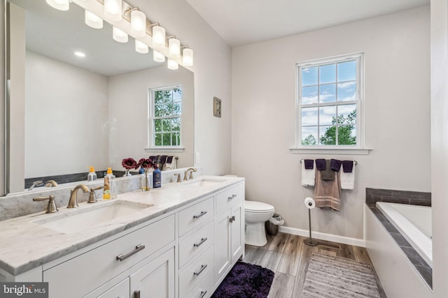 1723 Magnolia Ct, Garnet Valley, PA 19060 - full bath with toilet, double vanity, wood finished floors, a bath, and baseboards