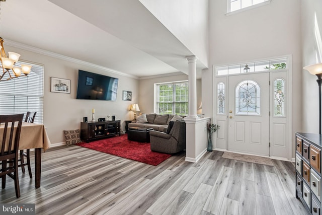 1723 Magnolia Ct, Garnet Valley, PA 19060 - entryway with decorative columns, light wood-style flooring, ornamental molding, a chandelier, and baseboards
