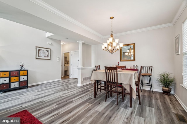 1723 Magnolia Ct, Garnet Valley, PA 19060 - dining room with wood finished floors, a chandelier, baseboards, and crown molding