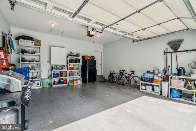 1723 Magnolia Ct, Garnet Valley, PA 19060 - garage with freestanding refrigerator and a garage door opener
