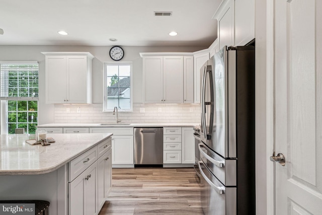 1723 Magnolia Ct, Garnet Valley, PA 19060 - kitchen with stainless steel appliances, a sink, white cabinetry, recessed lighting, and light wood-type flooring