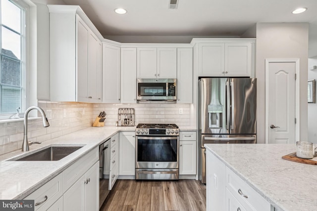 1723 Magnolia Ct, Garnet Valley, PA 19060 - kitchen featuring appliances with stainless steel finishes, a sink, white cabinetry, recessed lighting, and light wood-style floors
