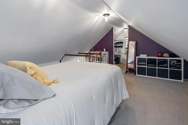 carpeted bedroom with lofted ceiling