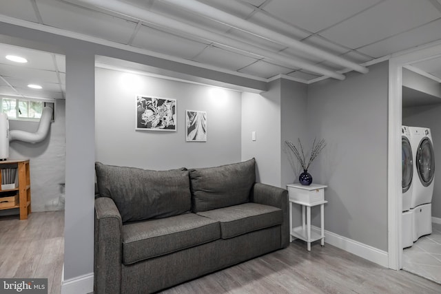 living area featuring independent washer and dryer, wood finished floors, and recessed lighting