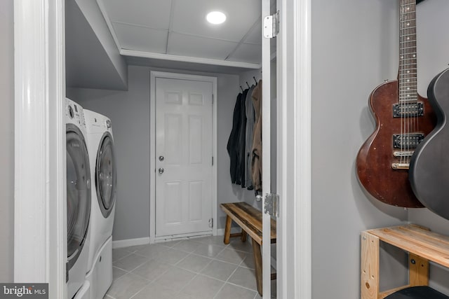 laundry room featuring baseboards and light tile patterned flooring