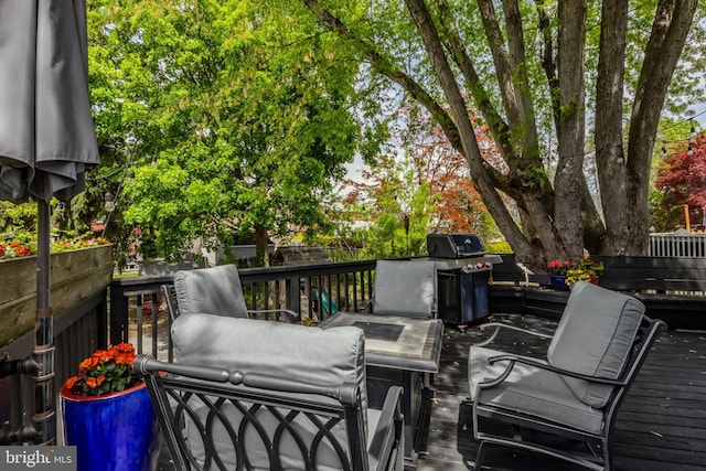 wooden terrace with a grill and fence