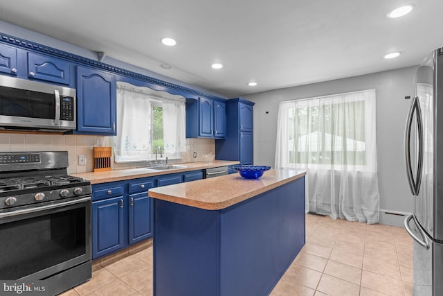 217 Lake Ave, Hamilton, NJ 08610 - kitchen featuring stainless steel appliances, blue cabinetry, a sink, light countertops, and light tile patterned floors