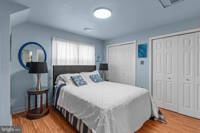 217 Lake Ave, Hamilton, NJ 08610 - bedroom featuring two closets, wood finished floors, attic access, and baseboards