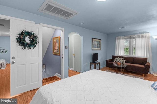 217 Lake Ave, Hamilton, NJ 08610 - bedroom featuring arched walkways, light wood-style floors, and baseboards
