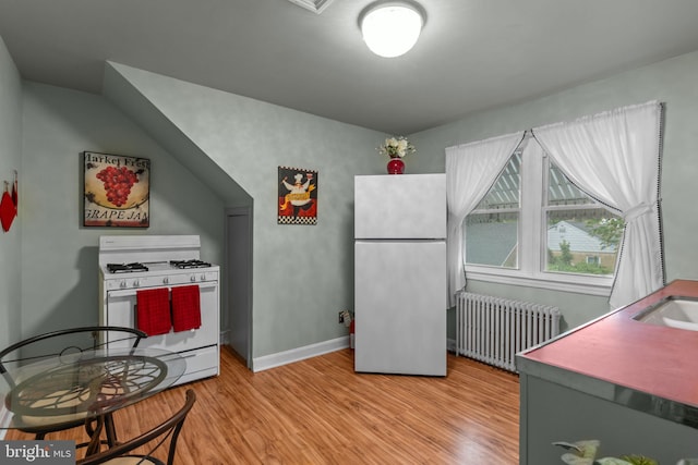 217 Lake Ave, Hamilton, NJ 08610 - kitchen featuring radiator, white range with gas cooktop, freestanding refrigerator, light wood-style floors, and baseboards