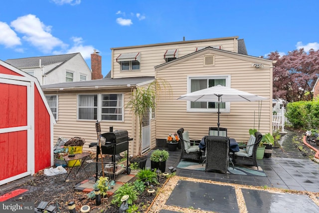 217 Lake Ave, Hamilton, NJ 08610 - rear view of property with a patio area, a storage unit, an outdoor structure, and outdoor dining area