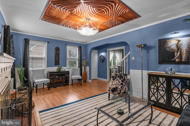 217 Lake Ave, Hamilton, NJ 08610 - foyer entrance with arched walkways, wood finished floors, a raised ceiling, and wainscoting