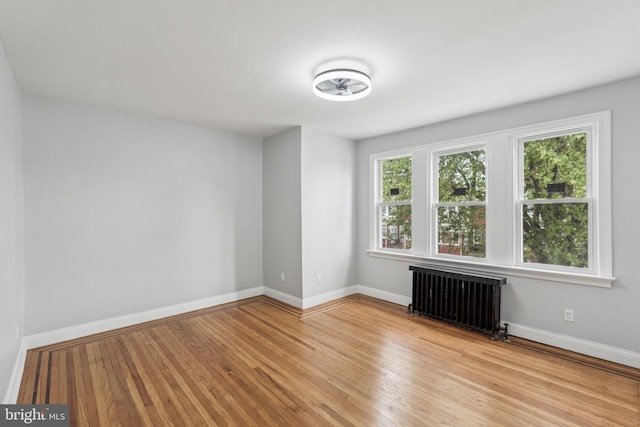 860 Foulkrod St, Philadelphia, PA 19124 - empty room featuring radiator heating unit, light wood-style floors, and baseboards