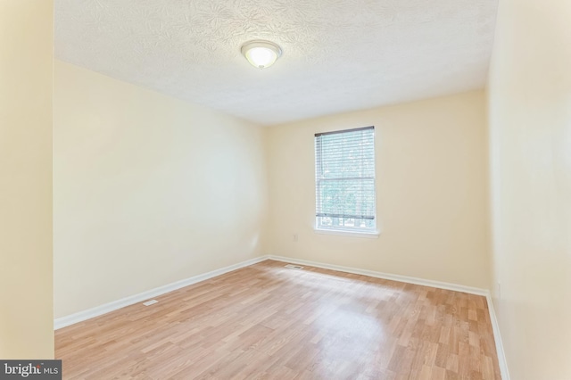 8151 Mandan Ter, Greenbelt, MD 20770 - unfurnished room featuring light wood-type flooring, baseboards, and a textured ceiling