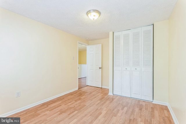 8151 Mandan Ter, Greenbelt, MD 20770 - unfurnished bedroom with light wood-style flooring, a closet, baseboards, and a textured ceiling