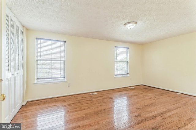 8151 Mandan Ter, Greenbelt, MD 20770 - unfurnished bedroom featuring light wood-type flooring, a textured ceiling, baseboards, and a closet