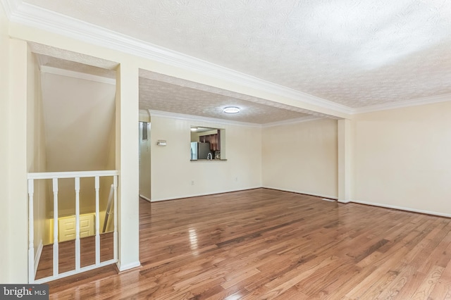8151 Mandan Ter, Greenbelt, MD 20770 - unfurnished room featuring a textured ceiling, wood finished floors, ornamental molding, and baseboards