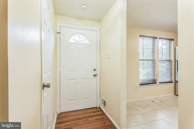 8151 Mandan Ter, Greenbelt, MD 20770 - foyer entrance with a textured ceiling and baseboards