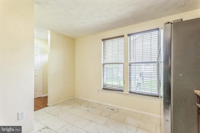 8151 Mandan Ter, Greenbelt, MD 20770 - empty room featuring marble finish flooring, baseboards, and a textured ceiling