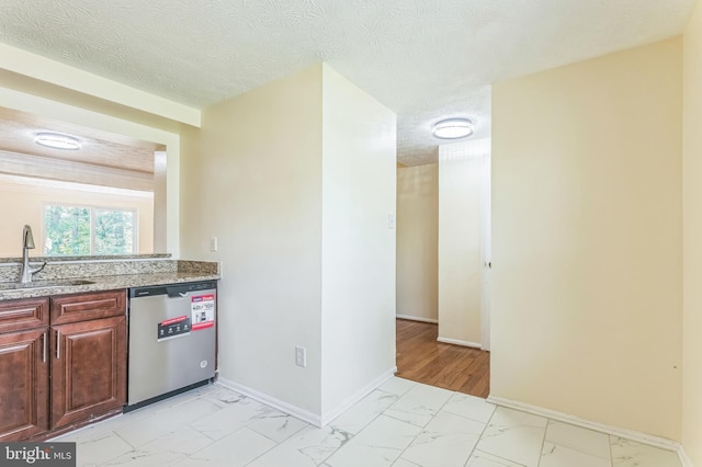 8151 Mandan Ter, Greenbelt, MD 20770 - kitchen featuring a sink, dishwasher, light marble finish flooring, baseboards, and light stone counters