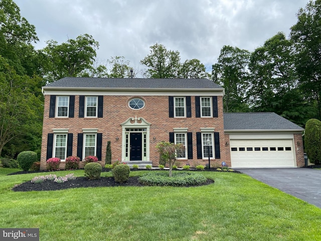3619 Beaver Ford Rd, Woodbridge, VA 22192 - colonial-style house with driveway, a garage, a front yard, and brick siding