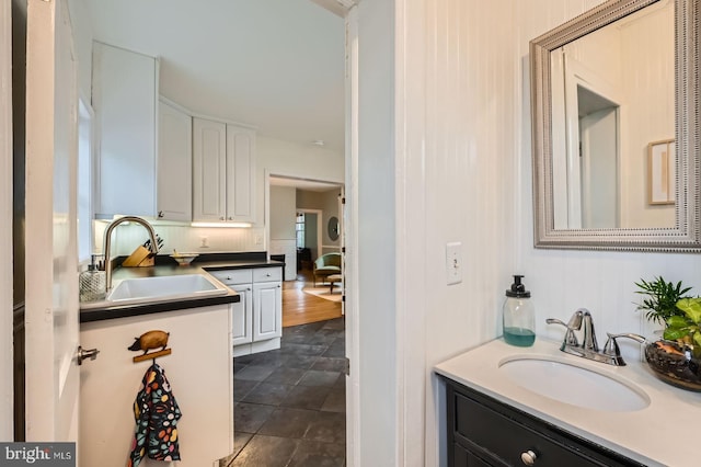 bathroom featuring vanity and stone finish floors